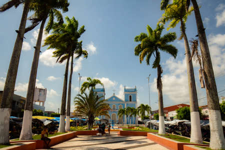 Goianinha, Brazil. August 17, 2019. Old church in the central square of the city. Portuguese architecture in the northeast of Brazil. Catholic temple framed by palm trees.のeditorial素材