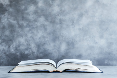 Open book on concrete wall background. Education concept. Mock up, 3D Renderingの素材