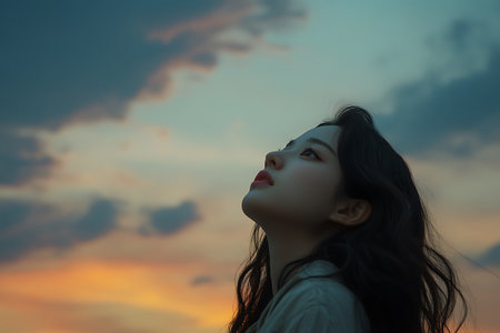 Portrait of beautiful asian woman with sunset sky background, vintage toneの素材