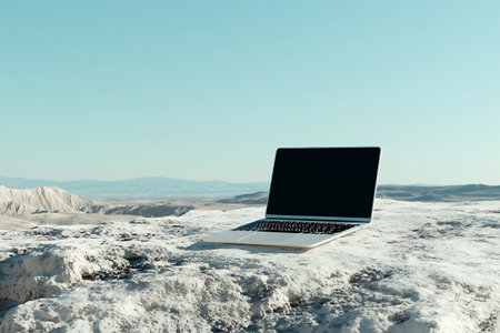 Laptop with blank screen on snowy mountain background. 3D Renderingの素材