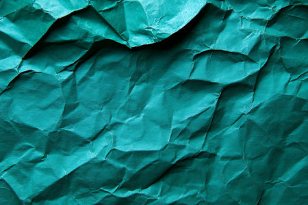 Green crumpled paper texture for background. Top view. Copy space.の素材