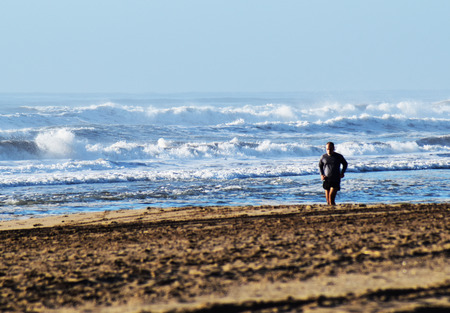 Man running on the beach at sunrise in pinamar 2の写真素材