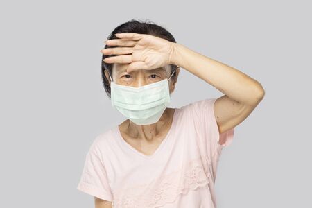 old asian woman feel have fever and sickの写真素材