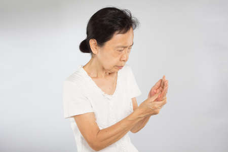 old asian woman feel hand muscle injuryの写真素材