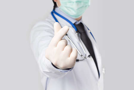 doctor held his hand to mark love in gray backgroundの写真素材