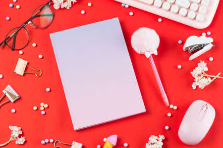flat lay stationery on work desk in red pastel background