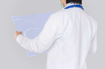 doctor checks hologram of liver function in gray backgroundの写真素材