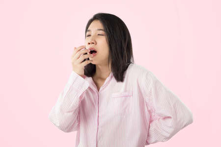 woman yawn and stretch when her wake up feeling sleepyの写真素材