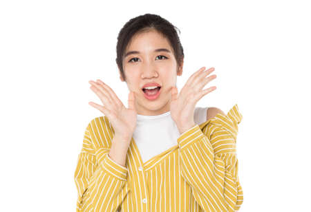 asian teenage girl shouting show excitement on white backgroundの写真素材