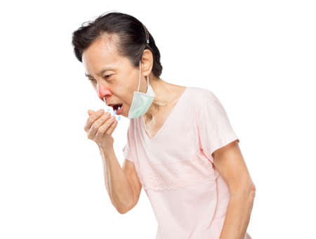 old asian woman due to cough spread saliva and sore throatの写真素材