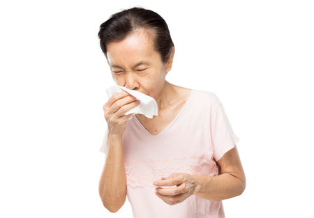old asian woman due to cough spread saliva and sore throat on white backgroundの写真素材