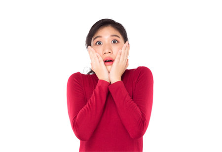 asian teenage girl covering her mouth surprise and shock on white backgroundの写真素材