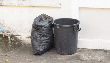 trash bin with rubbish pile on outdoor , littering conceptの写真素材