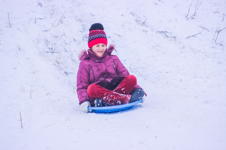 Zhytomyr, Ukraine - January 11, 2016: Sledding kids at winterのeditorial素材