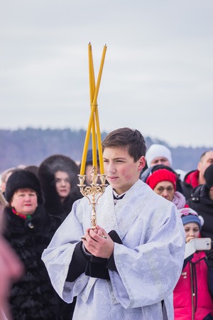 Zhytomyr, Ukraine - January 19, 2016: Religious kid holds candles
