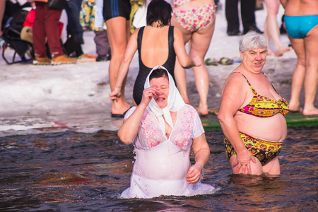 Zhytomyr, Ukraine - January 19, 2016: People celebrating epiphany at winter waterのeditorial素材