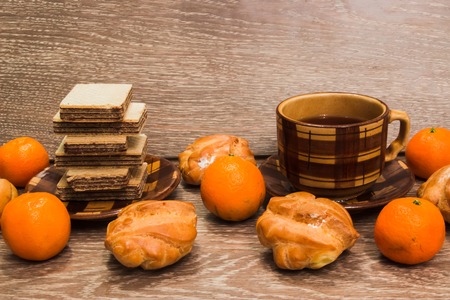 Chocolate waffles with tea, tangerines and croissantsの写真素材