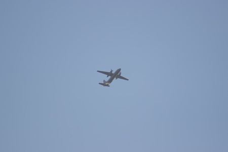 plane crossing sky at the evening grayの写真素材