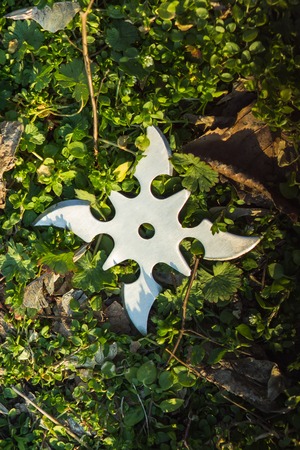 Ninja throwing metal star shuriken at glass