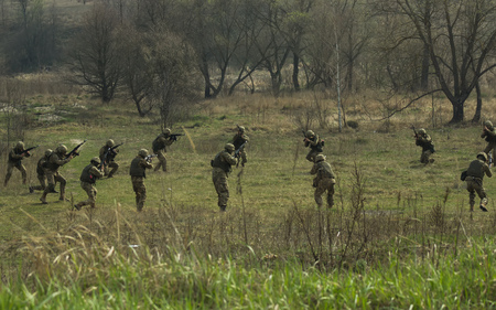 Military soldiers at tactical exercises with gunsの写真素材