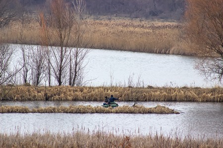 Two fishermen in the boat catching fishの写真素材