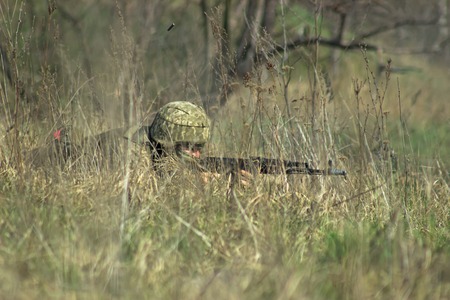 Military soldier at hideout with the kalashnikov