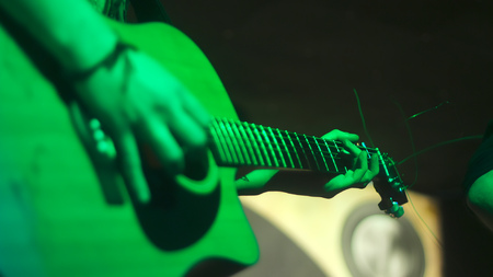 Man playing on guitar at the concertの写真素材