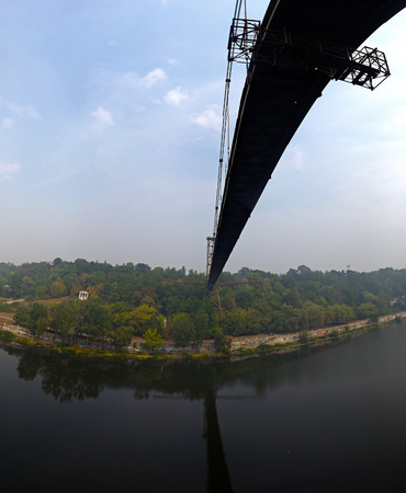 silhouette of people traveling across bridge