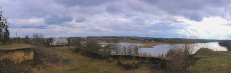 view to overcast landscape with the pondの写真素材