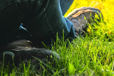 Cropped image of student sitting on the ground