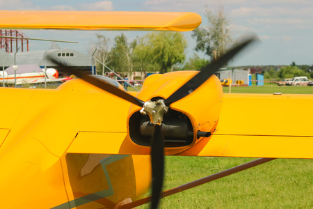 Yellow plane propeller turns at the airportの写真素材