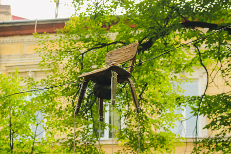 After the storm chair hangs on wiresの写真素材