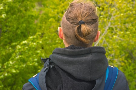 Young Man Traveler writing notes outdoor at tree backgroundの写真素材