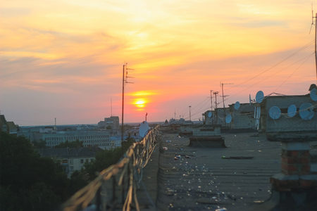 Evening wires on the roof with amazing cloudsの写真素材