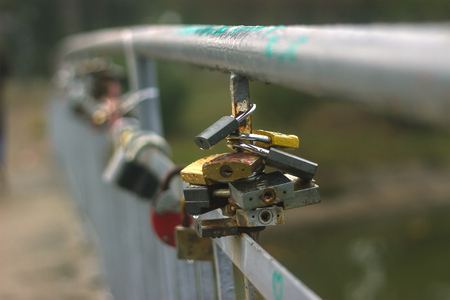 Rusty Padlock on the bridge with love signs