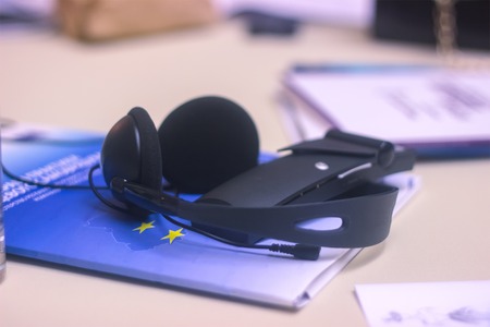 journalist work at a book with a voice recorder