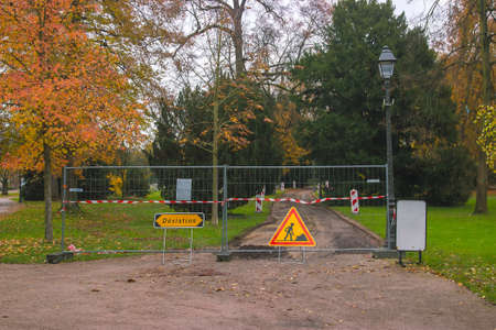 detour sign on road in front of the park