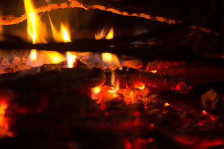 big red burning logs at fire placeの写真素材