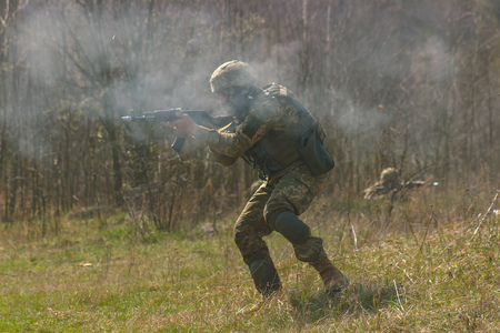 Front Line. Military attack on battlefield with gun from ambush