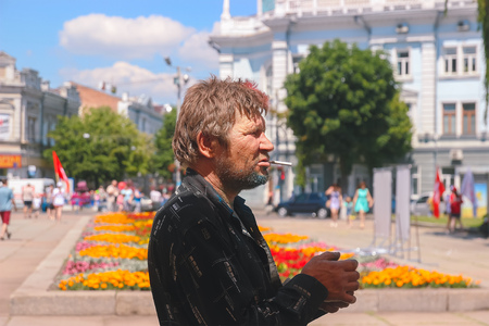Zhytomyr, Ukraine - June 25, 2016: beggar with sigarette partying among colorful powder cloud at holi fest, festival of colors in summer, amazing moment, then run competitionのeditorial素材