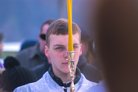 Zhytomyr, Ukraine - January 19, 2016 Religious kid holds candles
