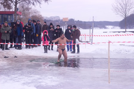 Zhytomyr, Ukraine - January 19, 2016: People celebrating epiphany at winter waterのeditorial素材