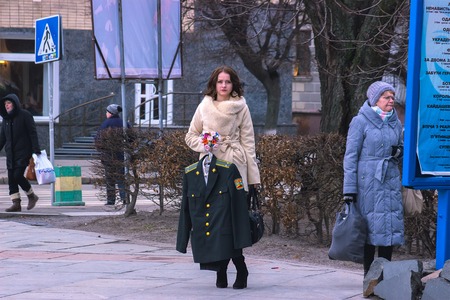 Zhytomyr, Ukraine - SEPTEMBER 15, 2015: Girl holds military costume during People protesting against government against tax growthのeditorial素材