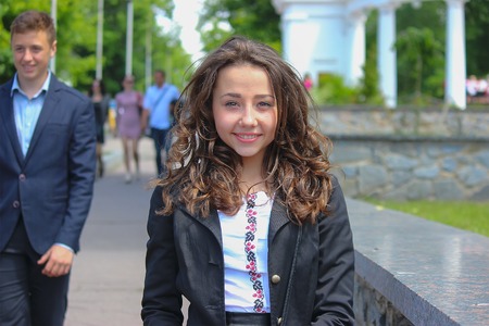 Zhytomyr, Ukraine - September 03, 2015: Young kids return home from school at Mala Berdychivska streetのeditorial素材