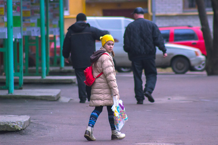 Zhytomyr, Ukraine - September 03, 2015: Young kids return home from school at Mala Berdychivska streetのeditorial素材