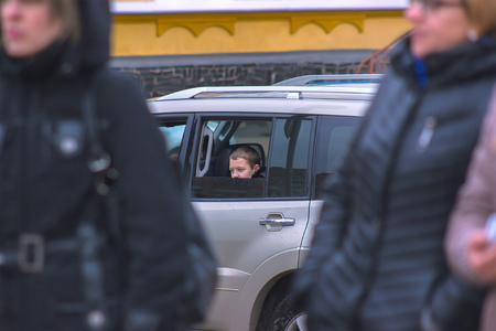 Zhytomyr, Ukraine - May 28, 2015: A young scared child is looking out the car windowのeditorial素材