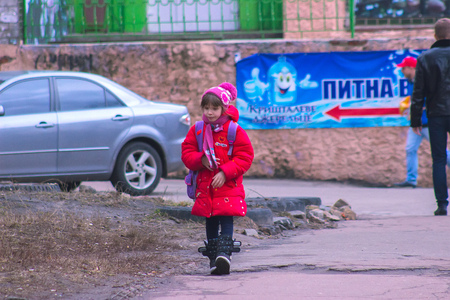 Zhytomyr, Ukraine - September 03, 2015: Young kids return home from school at Mala Berdychivska streetのeditorial素材