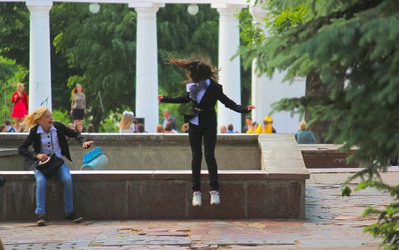 Zhytomyr, Ukraine - SEPTEMBER 2, 2016: Schoolgirls jumping from the bridge at parkのeditorial素材