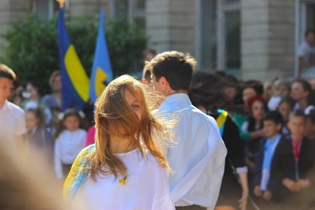 Zhytomyr, Ukraine - May 28, 2015: Last call for school holidays in school yard. Graduates of elementary middle school dance at the ball and release of doves of peace and friendship.のeditorial素材
