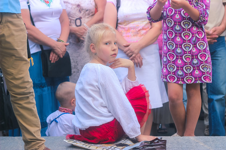 Zhytomyr, Ukraine - October 03, 2015: girl sitting and smiling in the crowdのeditorial素材